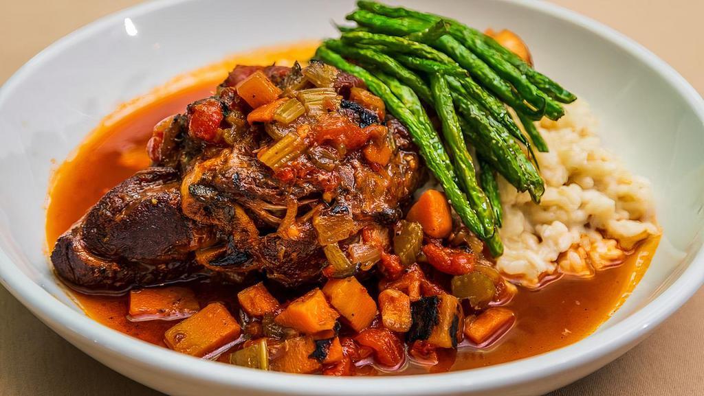 Hunter'S Style Lamb Shank · Superior farms slow-braised lamb with shiitake mushrooms, tomatoes, celery, onions and carrots in a red wine sauce served atop risotto.