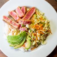Ahi Tuna Bowl · Steamed rice seasoned with Tajin, cabbage, Persian cucumbers, julienned carrots, light ginge...
