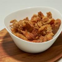 Chicken Chicharron · Fried chicken skins. Lightly seasoned and battered then deep-fried to a crisp.