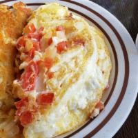 Greek Omelette · Feta cheese, tomato & onion. Served with homemade potatoes, toast & jelly.