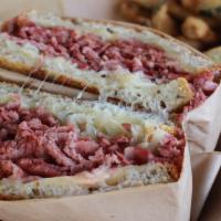 The Reuben · Our signature corned beef, topped with swiss cheese, sauerkraut and our homemade thousand is...