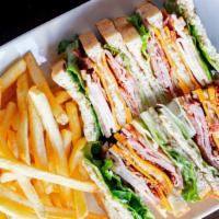The Club · Ham, oven roasted turkey, bacon, american cheese, lettuce, tomato, & mayo