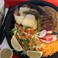 Plate #7: Carne Asada · Includes guacamole pico de gallo lettuces tortillas rice and beans.