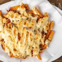 Loaded Fries · Roasted garlic fries with chicken, feta, Parmesan cheese and Caesar dressing.