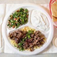 Beef Shawarma Plate · Marinated beef served on a bed of rice with one side of tahini sauce. Served with your choic...