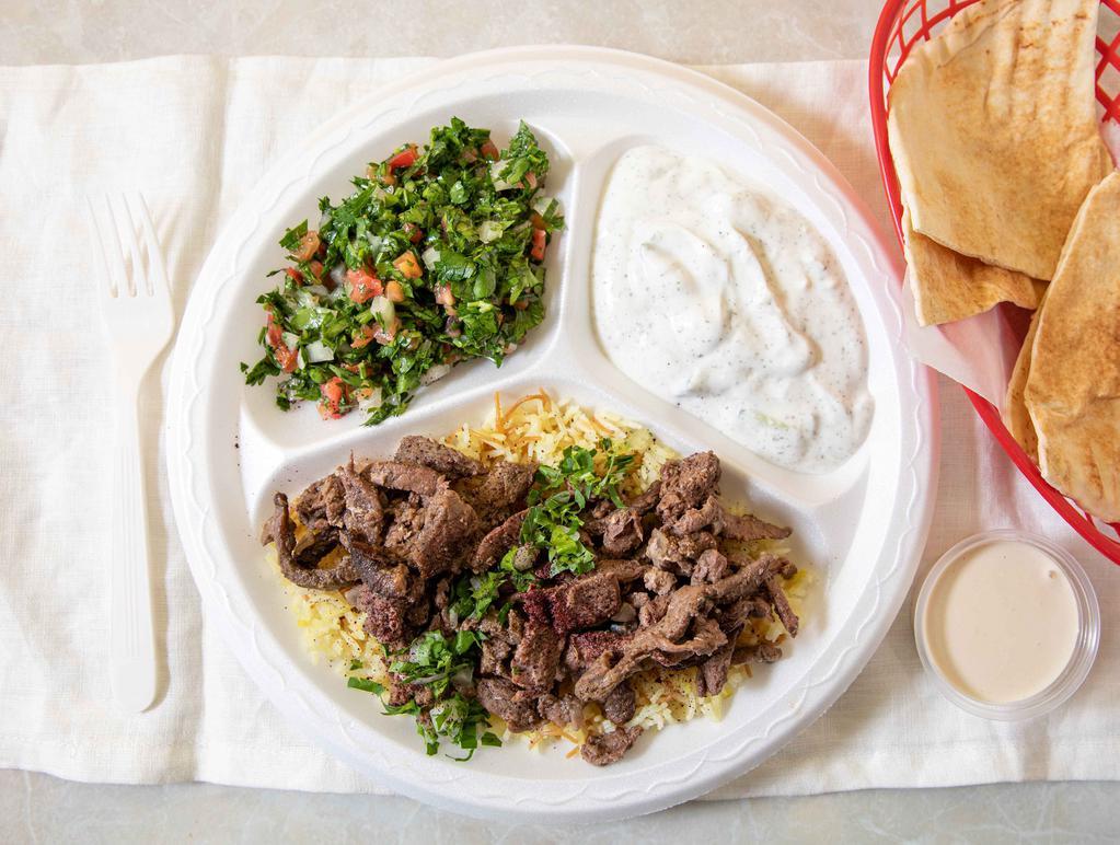 Beef Shawarma Plate · Marinated beef served on a bed of rice with one side of tahini sauce. Served with your choice of two sides and one pita bread.