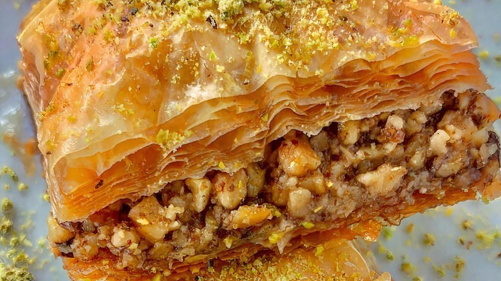 Baklava · 2 pieces of our house made baklava, made with walnuts, topped with simple syrup, infused with rose water and orange blossom.