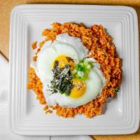 Kimchi Spam Fried Rice · Rice fried with fermented kimchi, spam, vegetables, and topped with an egg.