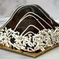 Chocolate Pyramid · Chocolate sponge with chocolate ganache and vanilla custard. Covered in more chocolate ganac...