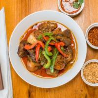 Panang Beef Curry · Stewed beef in panang curry, potatoes, bell peppers, and garnished with kaffir lime leaves. ...