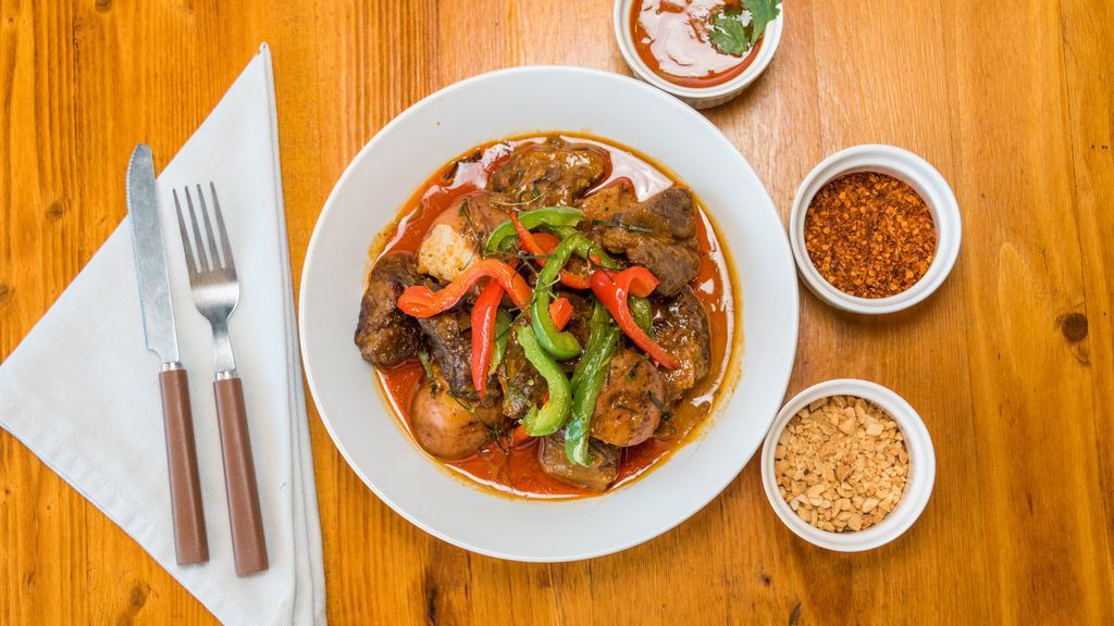 Panang Beef Curry · Stewed beef in panang curry, potatoes, bell peppers, and garnished with kaffir lime leaves. Served with white or brown jasmine rice.