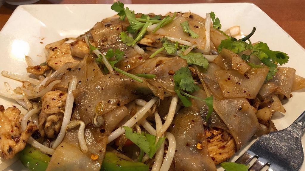 Drunken Noodles (Spicy Noodles) · Spicy pan-fried flat rice noodles with garlic, Thai chilies, bell peppers, bean sprouts, onions, and hot basil.