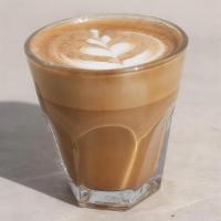 Flat White · A creamy espresso beverage with lightly steamed milk served in a 5 oz glass