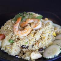 Pineapple Fried Rice · Fried rice with shrimp and chicken, egg, pineapple, tomatoes, raisin, and cashew nuts in cur...