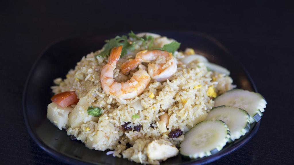 Pineapple Fried Rice · Fried rice with shrimp and chicken, egg, pineapple, tomatoes, raisin, and cashew nuts in curry powder.