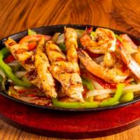 Fajitas De Pollo · Grilled marinated chicken breast slices, on sauté vegetable bed (seasoned onions, tomatoes a...