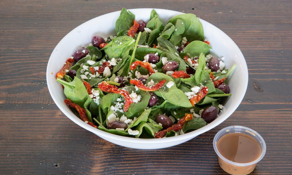 Greek Salad · Spinach, feta, Kalamata olives, sun-dried tomato, and balsamic dressing.
