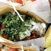Al Pastor Taco · A grilled taco with delicious asada, chicken, or juicy al pastor, topped with cilantro and o...