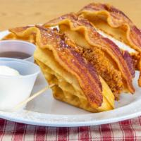 Chicken N’ Waffles · Fried chicken breast wedged between a Belgian waffle, topped with bacon.