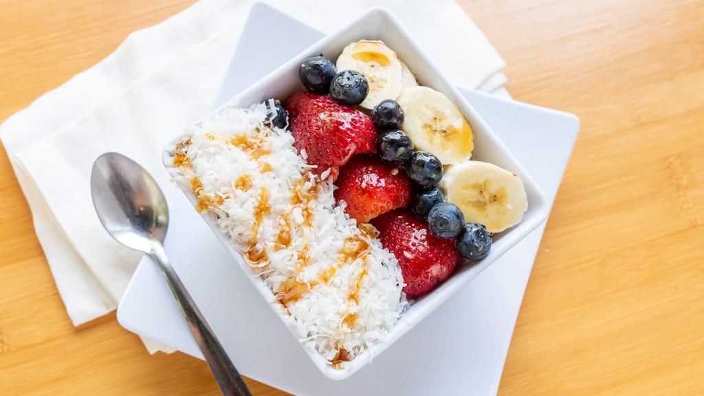 Coconut Bowl · A supper healthy breakfast bowl has Organic Acai fruit as a base and topped with Granola, Banana, Strawberries, Coconut, and Honey.
