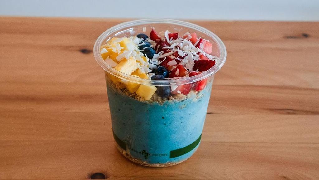 Blue Hawaii Smoothie Bowl · Crafted with Almond Milk, Banana, Blue Spirulina, Mango, Pineapple, Date, and Coconut Butter. Topped with GF Granola, Strawberry, Blueberry, Pineapple, and  Coconut Chips.
