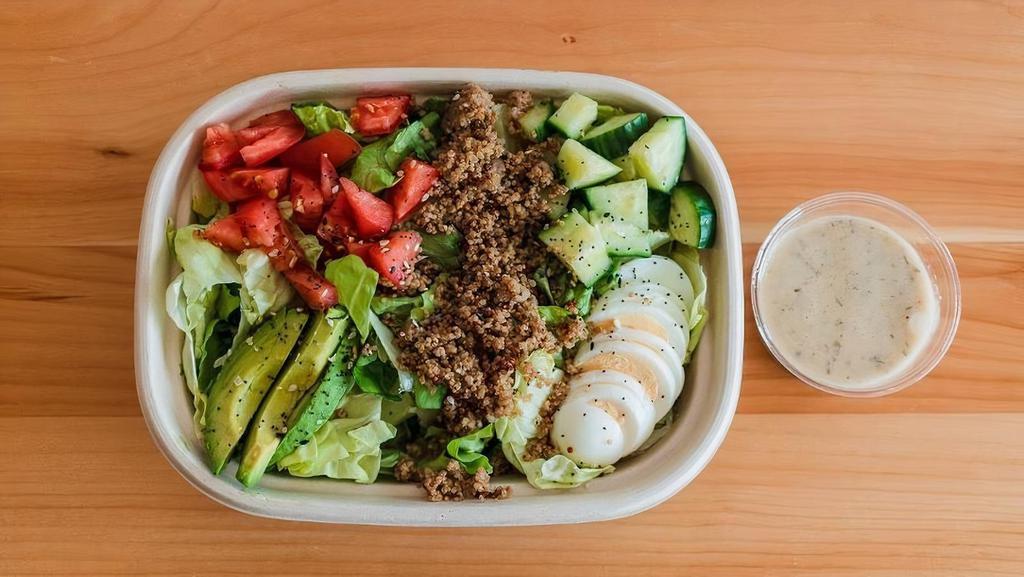 Cobb Grain Bowl · Crafted with Mixed Greens, Avocado, Hard Boiled Egg, Cucumber, Tomato, Red & White Quinoa, Everything Seasoning, and Lime Vinaigrette.