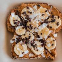 Coconut Peanut Butter · Multi Grain Toast topped with Coconut Peanut Butter, Banana, Cacao Nibs, Organic Coconut Chi...