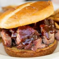Tri Tip Sandwich · House smoked tri tip on a brioche bun served with a side of chips
