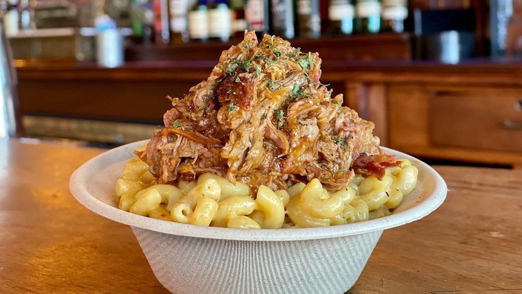 Pulled Pork & Mac · Our house smoked pulled pork piled on top of our house made Mac-n-cheese
