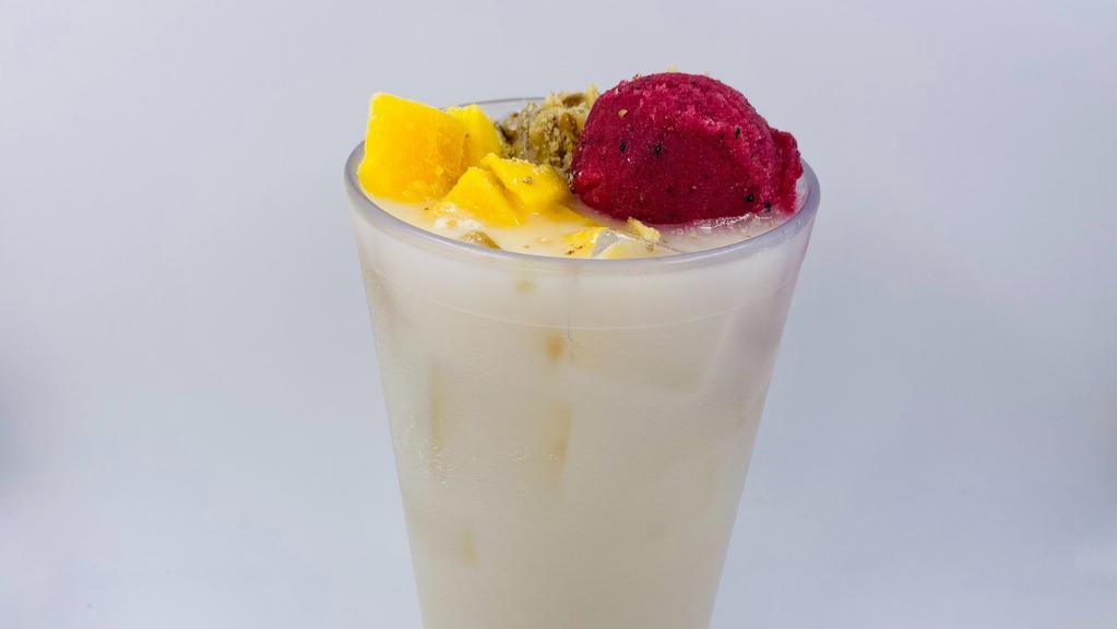 Horchata With Pitaya · Horchata topped with pitaya sorber (dragón fruit) crushed walnuts and mango chunks