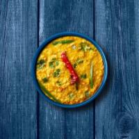 Light Yellow Dal  · Slow-cooked yellow lentils, tempered with tomatoes, onions, green chilis, and Indian spices....