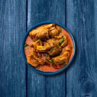 Capital Goat Curry · Tender chunks of goat simmered in brown onion and tomato curry, seasoned with fresh herbs an...