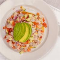 Tostada Ceviche De Pescado · Fish cooked in lime, mixed with pico de gallo, topped with avocado, and chili powder.