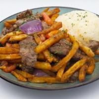 Rib Eye Lomo Saltado · Ribeye cut, thick fries with charred sweet red onions and tomatoes, white wine soy, home-mad...