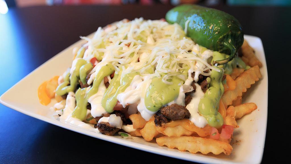 Guapo Fries · Choice of meat, cheddar cheese sauce, pico de gallo, sour cream, guacamole, jalapeños, and shredded cheese.