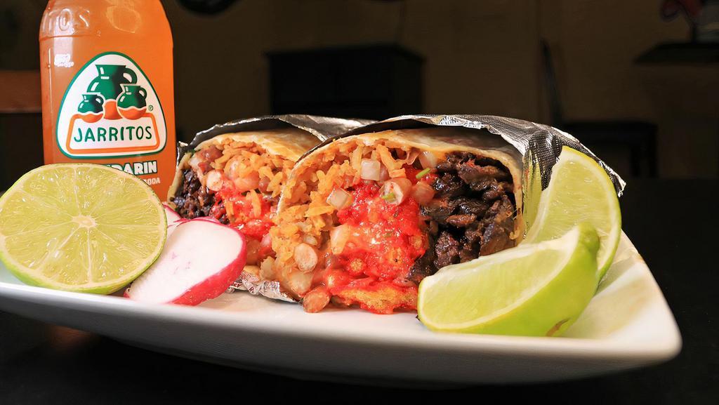 Hot Cheeto Burrito · Choice of meat Rice, Beans, Onion, Cilantro, Shredded Cheese, Cheese Sauce, Hot Cheetos