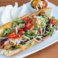 Banh Mi · French baguette, aioli, cilantro, chilies, pickled daikon, and carrot. Served with house-mad...