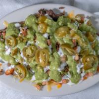 Asada Fries · French fries, topped with nacho cheese, carne asada (beef), sour cream and fresh homemade gu...