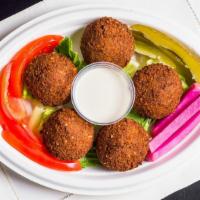 Falafel · Ground chickpeas mixed with special Mediterranean spices rolled into a ball and fried served...