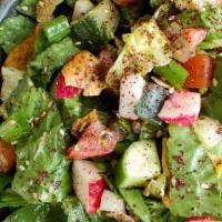 Fattoush · Lettuce, cucumbers, tomatoes, green pepper, radishes, fried pieces of pita bread, blended wi...