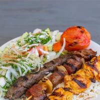 Combination Kabob Plate · Chicken kebob, kofta kebob, beef kebob, over a bed of rice with a side of salad, grilled tom...