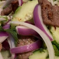 Yum Nuah (Beef Salad) · Grilled marinated beef tossed in lime dressing with white, red, green onions, cilantro, toma...