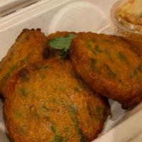Fish Cake (5) · Thai fish cakes marinated with our red curry served with sweet and chili sauce topped with c...