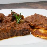 Braised Short Ribs · slow cooked boneless beef short ribs + short ribs ravioli, parmigiano.