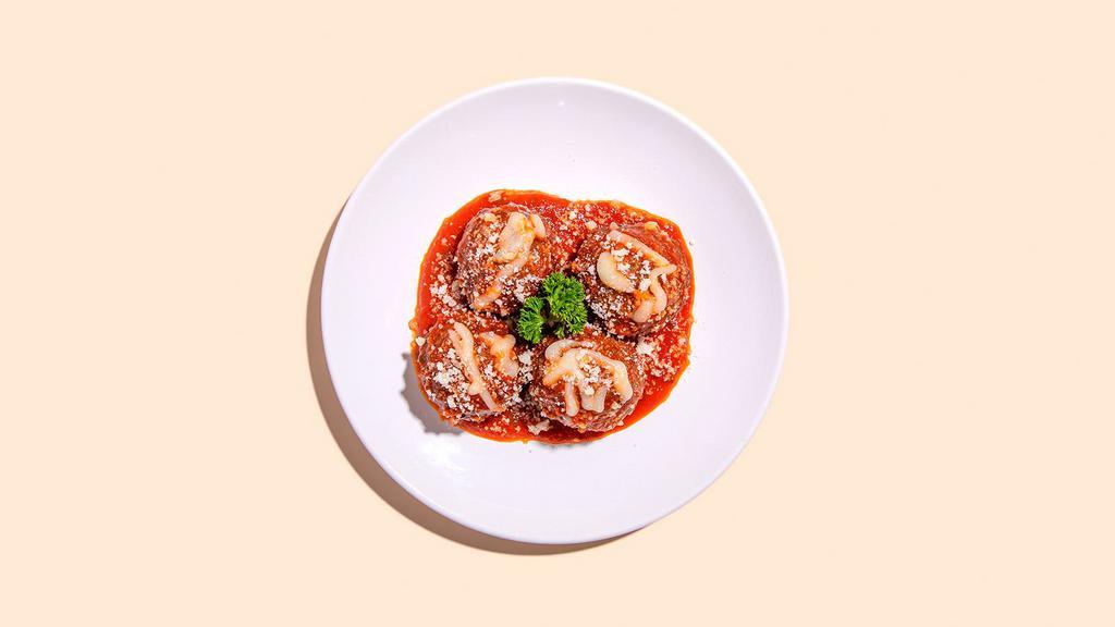 Baked Meatball Parmesan · Four meatballs covered in Ma's Sunday Sauce and topped with melted mozzarella and fresh Parm.