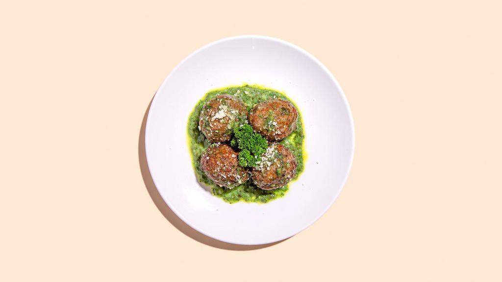 Pesto Meatballs · Four meatballs covered in savory basil pesto.