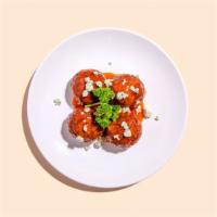 Buffalo Meatballs · Four meatballs slathered in buffalo sauce, and topped with crumbles of blue cheese and a dri...