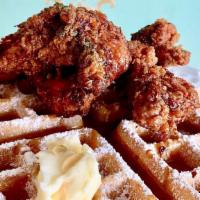 Chicken & Waffles · Two pieces of seasoned fried chicken on a classic waffle served with syrup and butter..