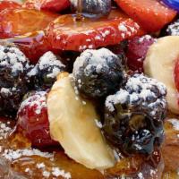 French Toast · Sweet French pan bread sliced, topped with banana, seasonal berries, and whipped cream. Serv...