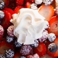 Waffle & Berries · Classic waffle topped with seasonal berries and whipped cream served with syrup.